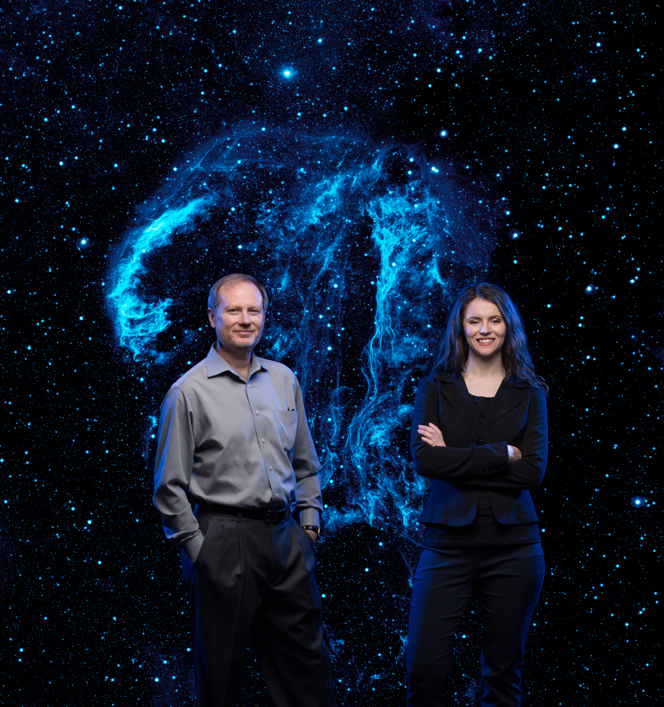 Physics Prof. Phillip Stancil & PhD student Renata Cumbee. Photographed in studio for illustration. NOTE: Star background is an ultraviolet image of the Cygnus Loop taken by NASA's Galaxy Evolution Explorer (NASA/JPL-Caltech