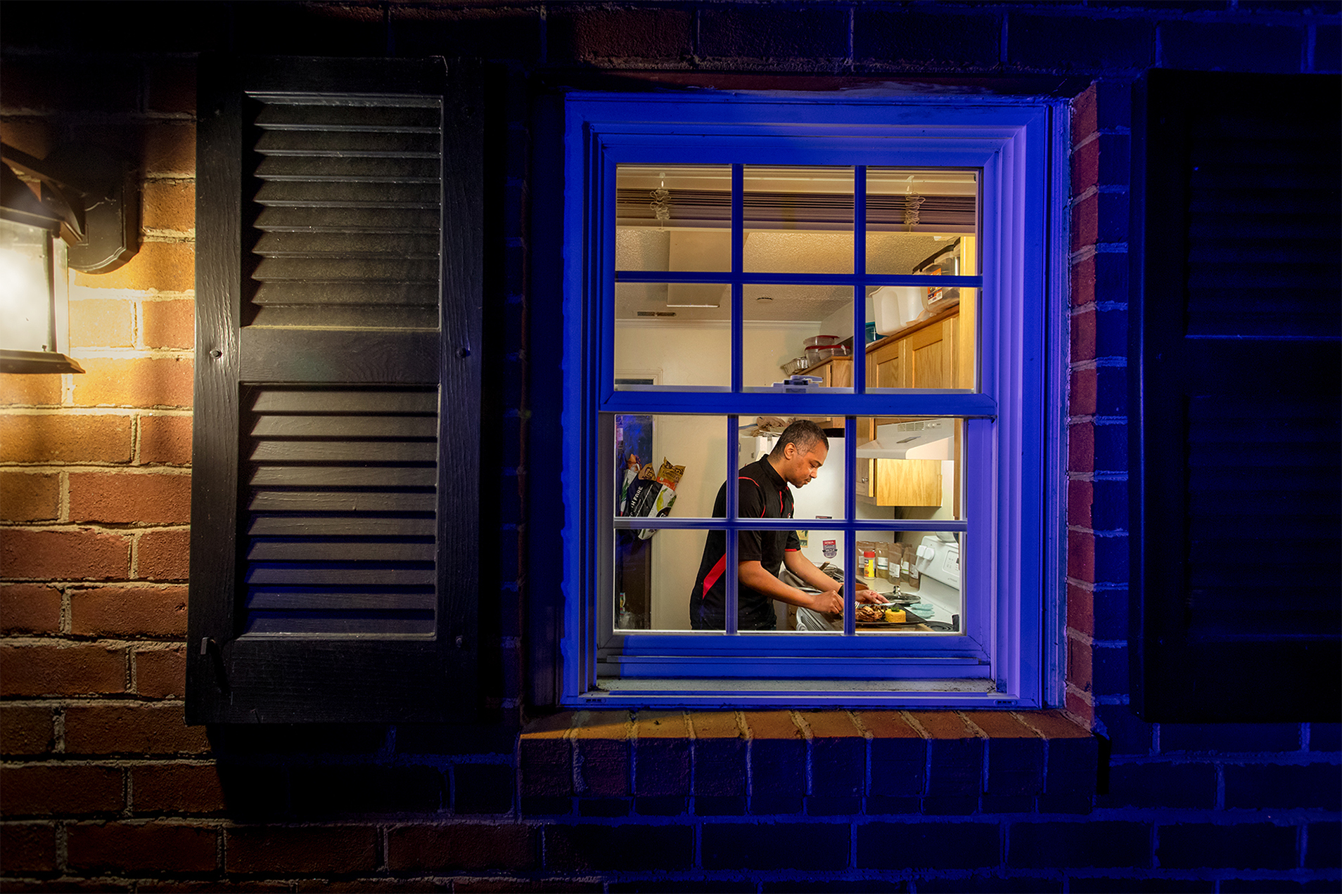 Marques Dexter cooking - view through window. 